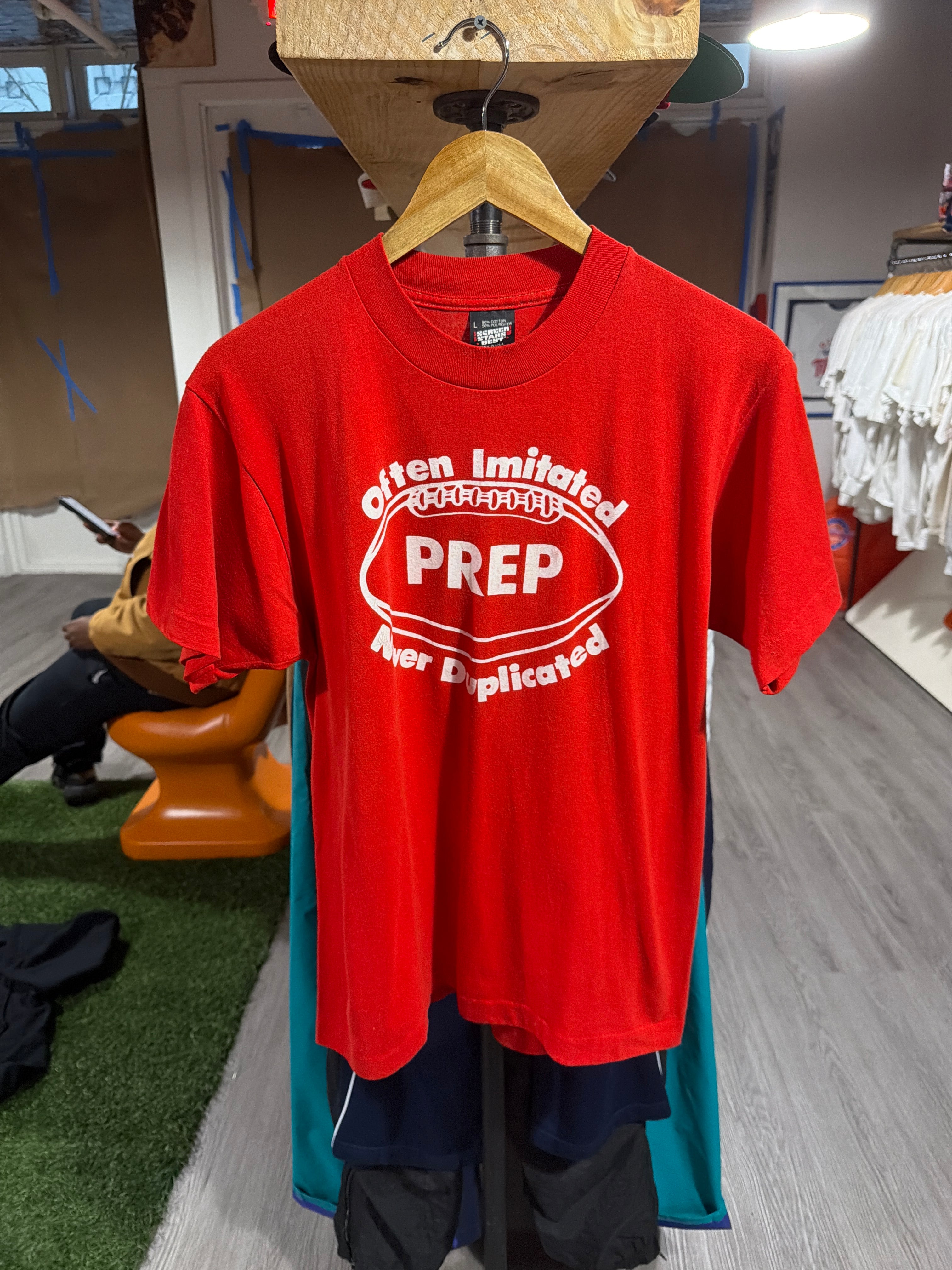 Prep “Often Imitated” Football Tee